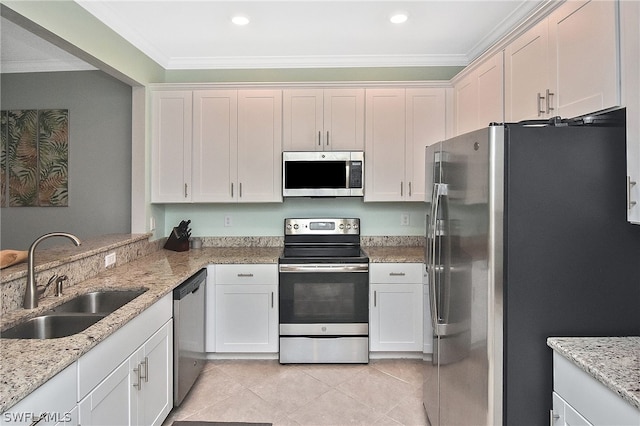 kitchen with stainless steel appliances, a sink, light tile patterned flooring, light stone countertops, and crown molding