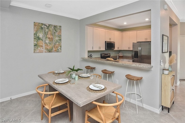 kitchen with kitchen peninsula, appliances with stainless steel finishes, crown molding, and light tile patterned flooring