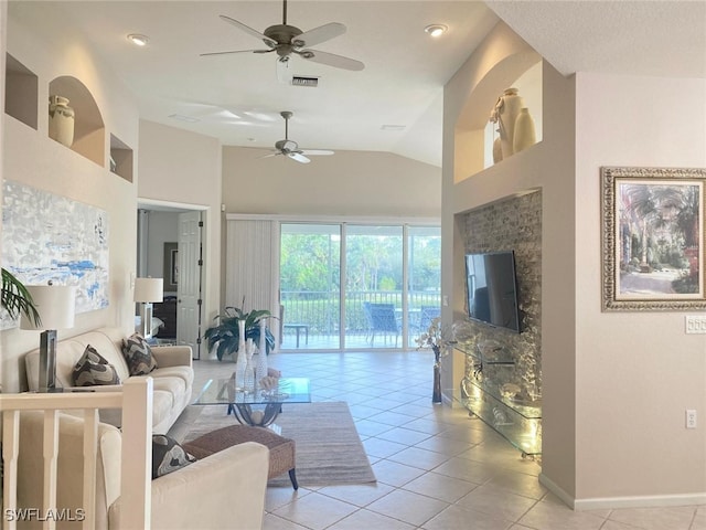 living room featuring ceiling fan, light tile patterned floors, and lofted ceiling