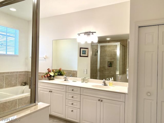 bathroom featuring plus walk in shower, tile patterned flooring, and vanity