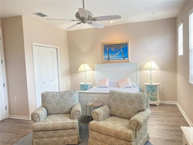 bedroom with ceiling fan, a closet, and hardwood / wood-style floors