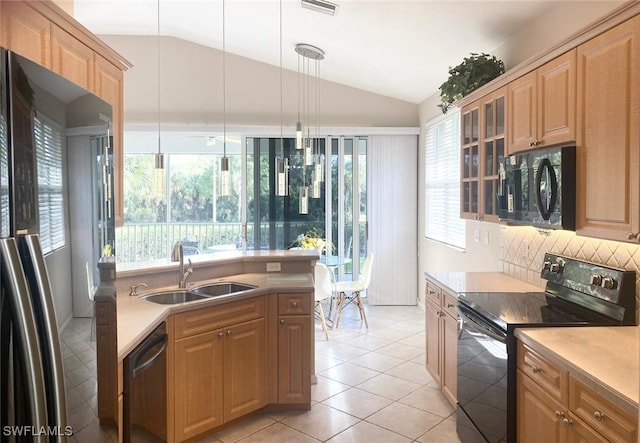 kitchen with sink, pendant lighting, vaulted ceiling, light tile patterned floors, and black appliances