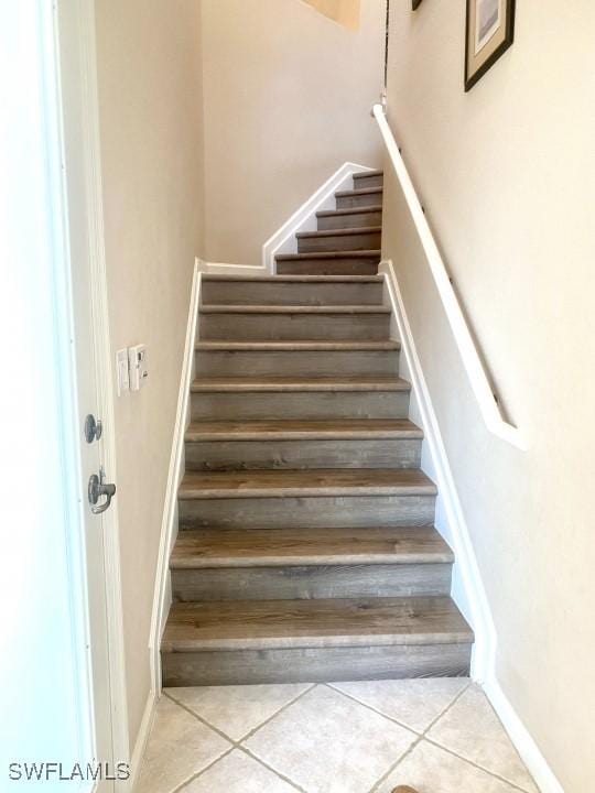 stairs featuring tile patterned flooring