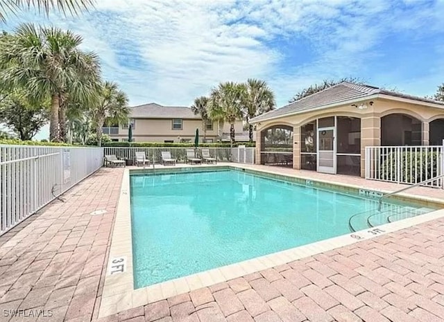 view of swimming pool featuring a sunroom