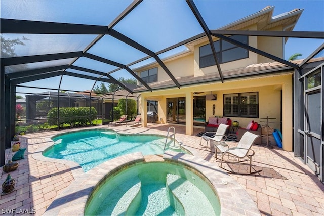 view of swimming pool with glass enclosure, an in ground hot tub, and a patio