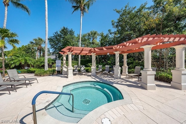 view of pool with a community hot tub, a pergola, and a patio area