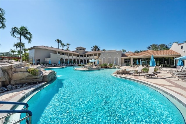 view of swimming pool featuring a patio and pool water feature