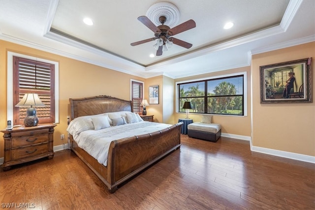 bedroom with ceiling fan, a raised ceiling, ornamental molding, and wood-type flooring