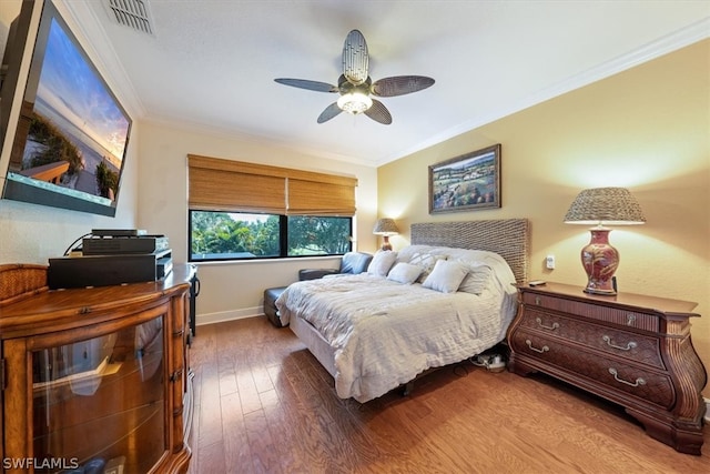 bedroom with ceiling fan, ornamental molding, and wood-type flooring