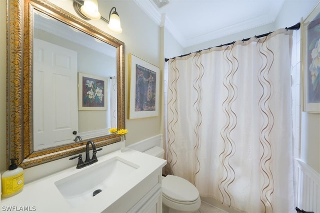 bathroom featuring vanity, toilet, and crown molding