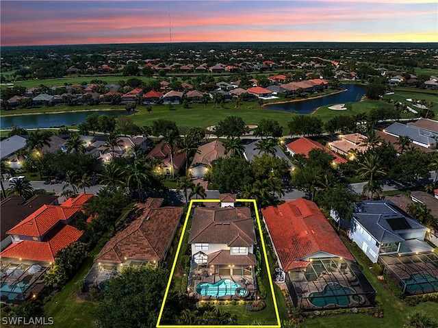 aerial view at dusk with a water view