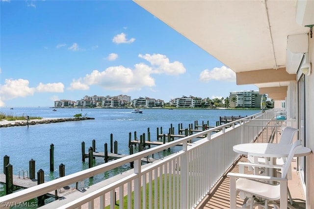 balcony featuring a water view and a dock