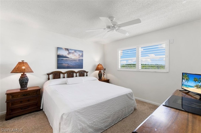 carpeted bedroom with a textured ceiling and ceiling fan