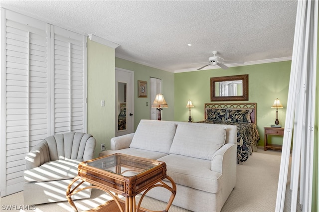 living room with ceiling fan, a textured ceiling, and carpet floors