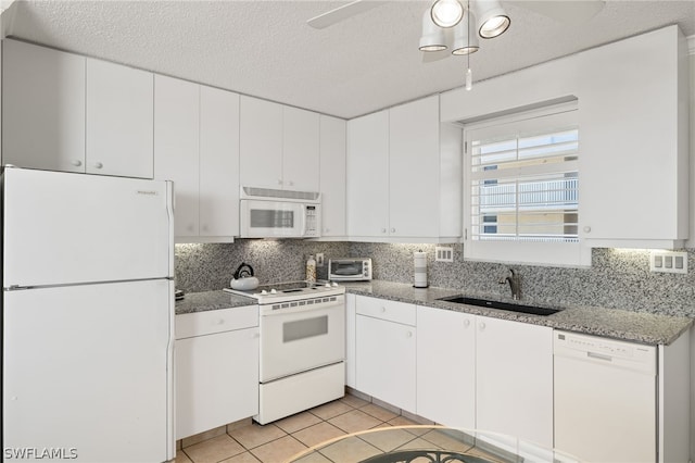 kitchen featuring ceiling fan, tasteful backsplash, white appliances, sink, and white cabinetry