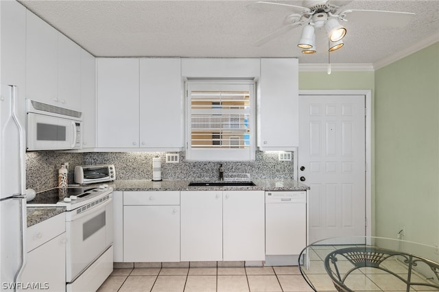 kitchen featuring sink, white appliances, white cabinetry, and backsplash