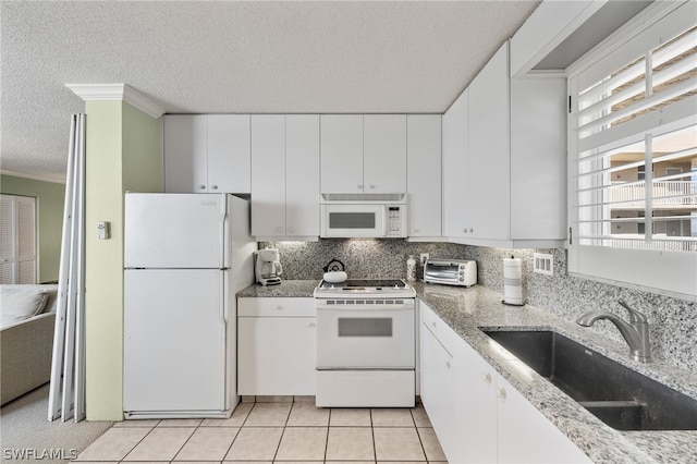 kitchen featuring white cabinetry, white appliances, backsplash, sink, and light tile floors