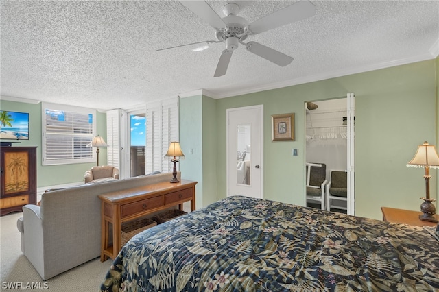 carpeted bedroom with crown molding, a textured ceiling, and ceiling fan