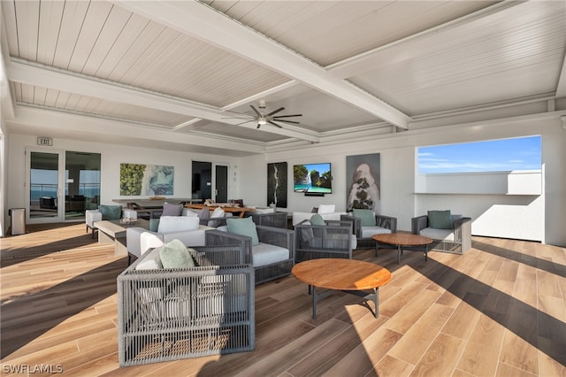 living room featuring beamed ceiling, ceiling fan, and wood-type flooring