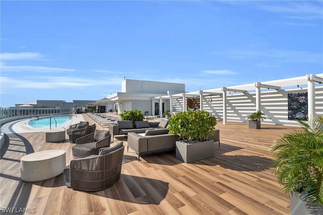 wooden terrace with a pergola, outdoor lounge area, and a fenced in pool