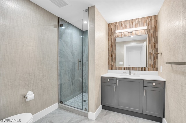 bathroom featuring tile flooring, a shower with shower door, toilet, and vanity