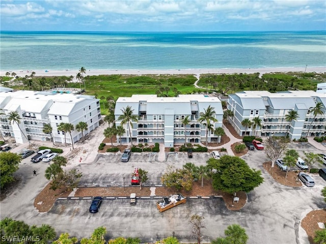 bird's eye view featuring a water view and a beach view