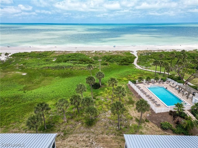 drone / aerial view with a water view and a view of the beach