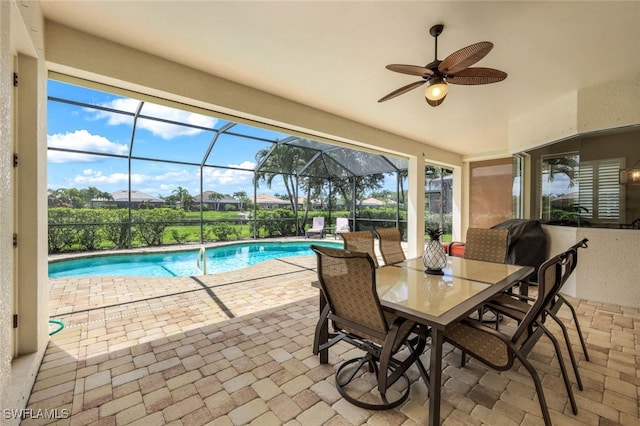 pool with ceiling fan, outdoor dining space, a lanai, and a patio area