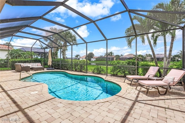 outdoor pool with a patio, outdoor lounge area, and glass enclosure