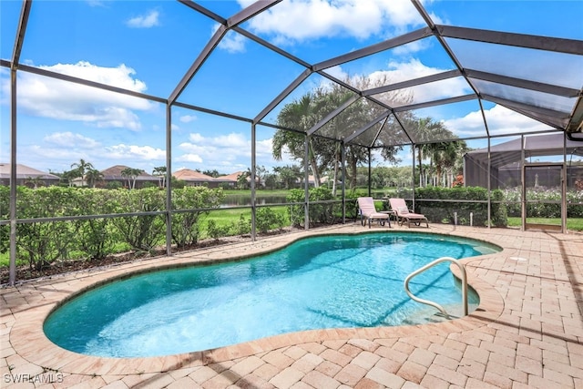 view of swimming pool featuring glass enclosure and a patio