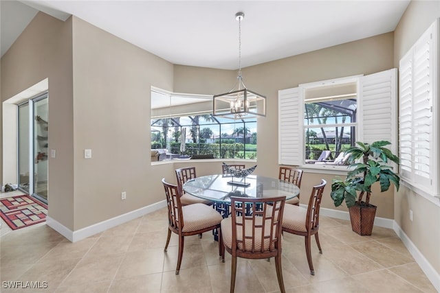 tiled dining area with an inviting chandelier