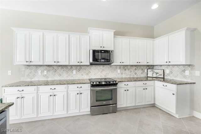 kitchen with white cabinetry, tasteful backsplash, light tile patterned floors, stainless steel appliances, and stone counters