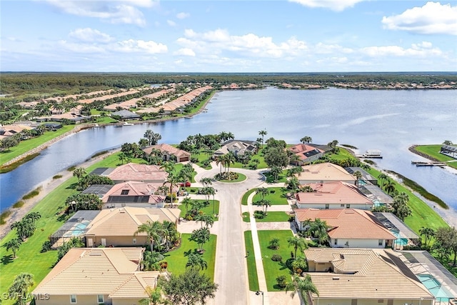 drone / aerial view featuring a residential view and a water view
