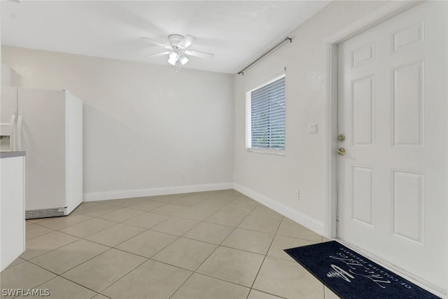 tiled entryway with ceiling fan