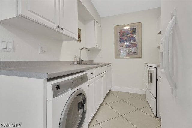 clothes washing area featuring sink, washer / clothes dryer, and light tile floors