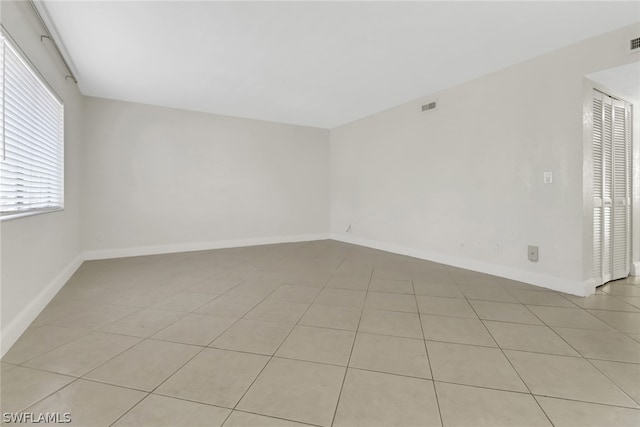 spare room featuring light tile floors