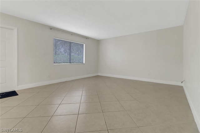 spare room featuring light tile floors