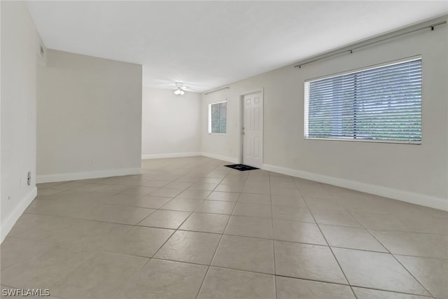 unfurnished room with light tile floors