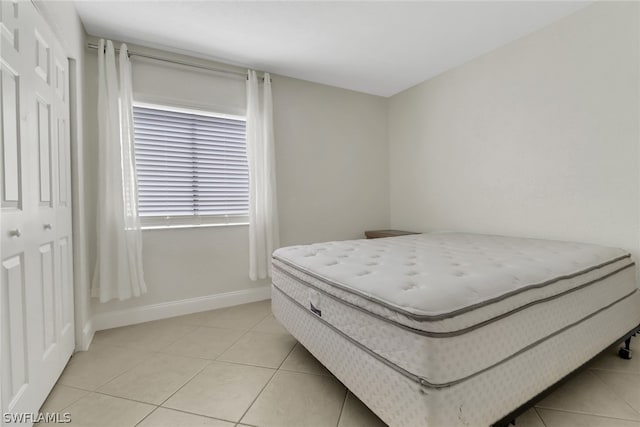 bedroom featuring light tile flooring