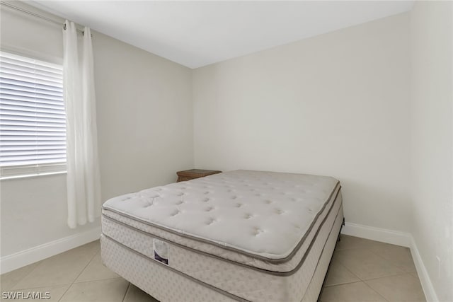 tiled bedroom with multiple windows