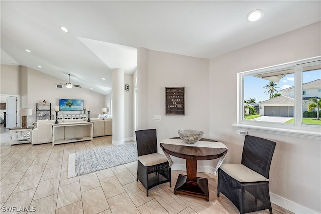 living area featuring light tile flooring, ceiling fan, and vaulted ceiling