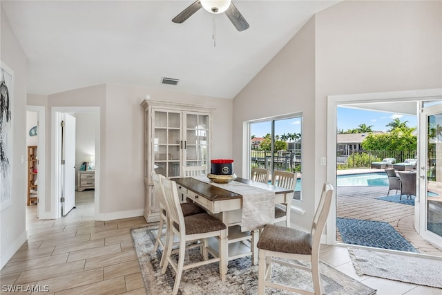 dining room featuring high vaulted ceiling and ceiling fan