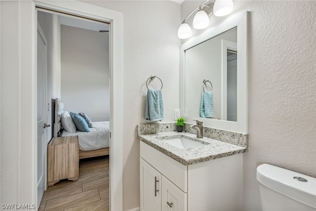 bathroom with vanity with extensive cabinet space and toilet