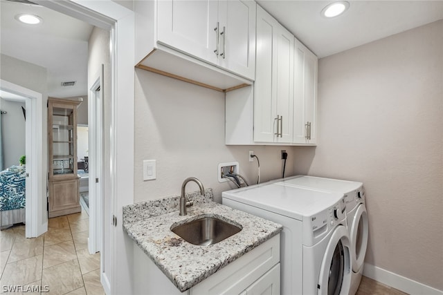 washroom with light tile flooring, washing machine and clothes dryer, hookup for a washing machine, sink, and hookup for an electric dryer