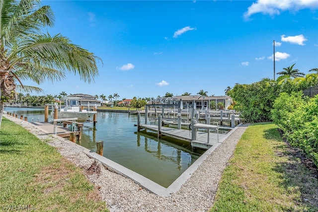 view of dock featuring a water view and a lawn