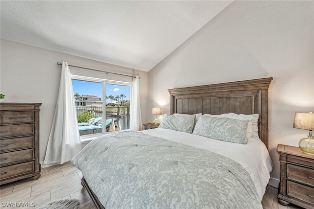 bedroom with access to outside and lofted ceiling