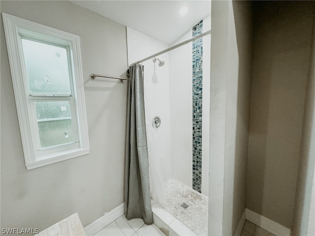 bathroom with tile flooring and a shower with shower curtain