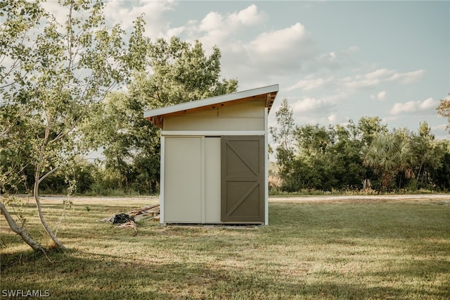 view of shed / structure with a lawn