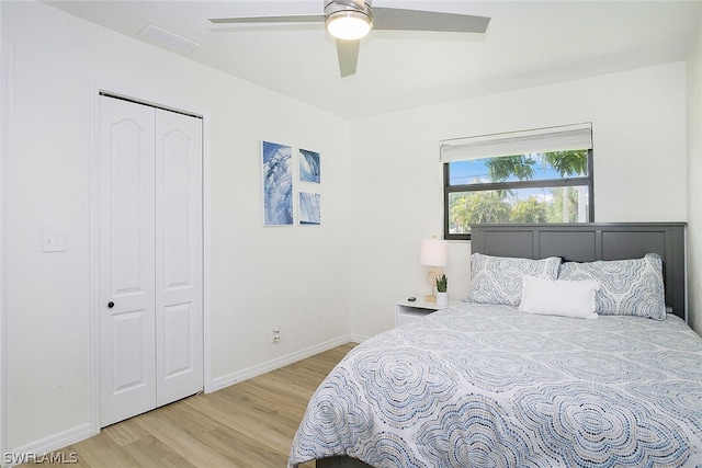 bedroom with light hardwood / wood-style floors, a closet, and ceiling fan