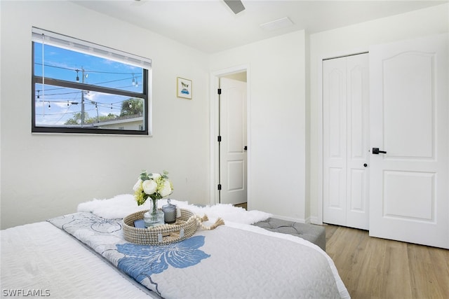 bedroom with a closet and light hardwood / wood-style floors